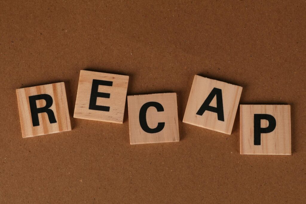 Conference-Event-Planning-Checklist_Man-wearing-glasses-headset, Scrabble tiles spell recap on brown background