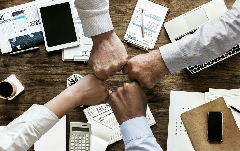 How to Choose the Right Event Company in Singapore for Your Next Corporate Project, Hands In Teamwork Pose